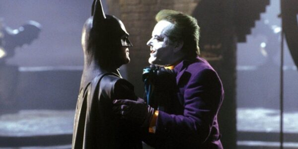 Batman picking up and threatening the Joker