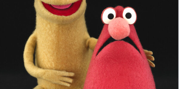 Two oblong puppets, yellow and red, one smiling, one frowning