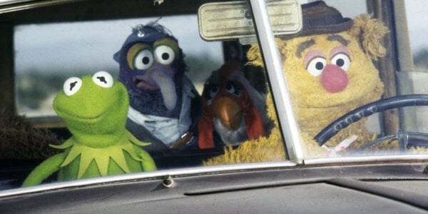 The characters Kermit, Gonzo, Camilla, and Fozzy, who are all puppets, are in a car.