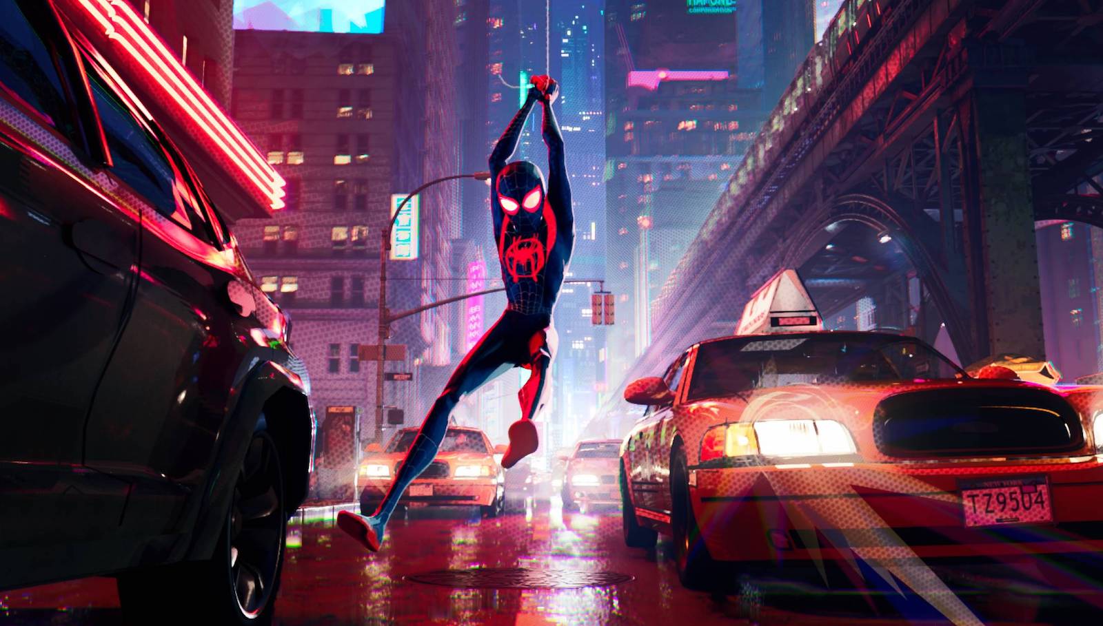 Spider-Man flies through a New York city street above taxicabs