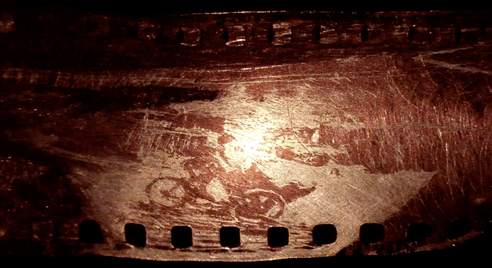 A degraded film strip with a bicycle visible on it.