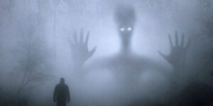 A ghost emerging in silhouette from the mist, with a small human figure in the foreground