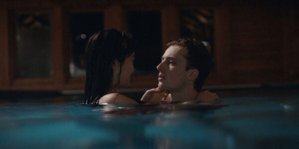 A young man and woman embracing in a pool
