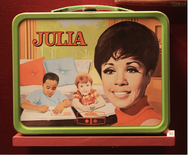 A picture of a lunch box featuring a drawing of Diahann Carroll from the TV show JULIA