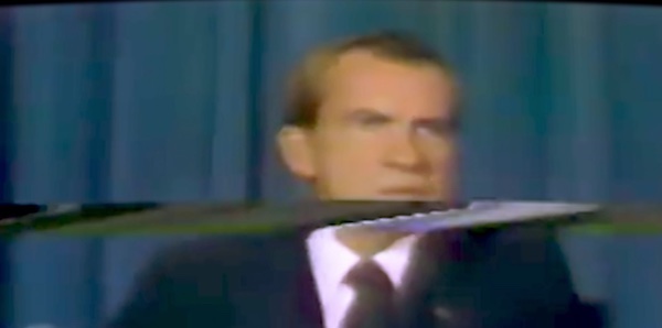 An image of Richard Nixon giving a presidential address, though the television image is distorted by static
