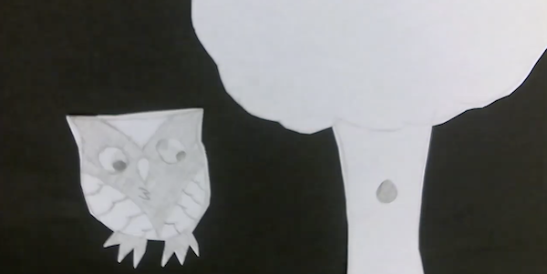 A black and white cut-out animation of an owl and a tree