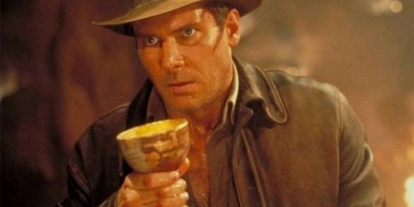 Adventurer Indiana Jones holds the Holy Grail in his hand