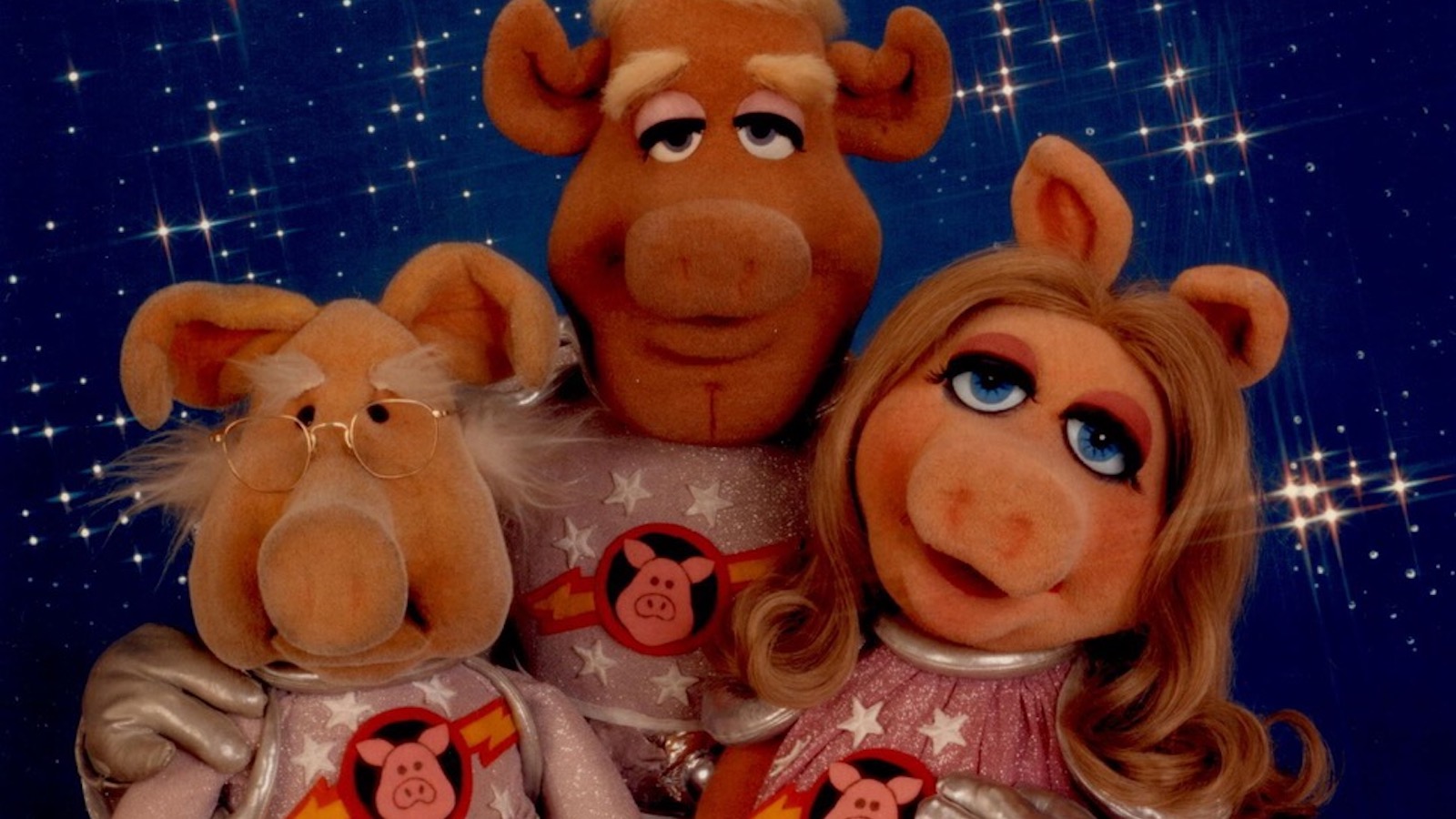 three muppet pigs in space suits in space