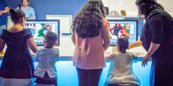 Children designing animations at the Museum's computer animation stop-motion studio computer screens.