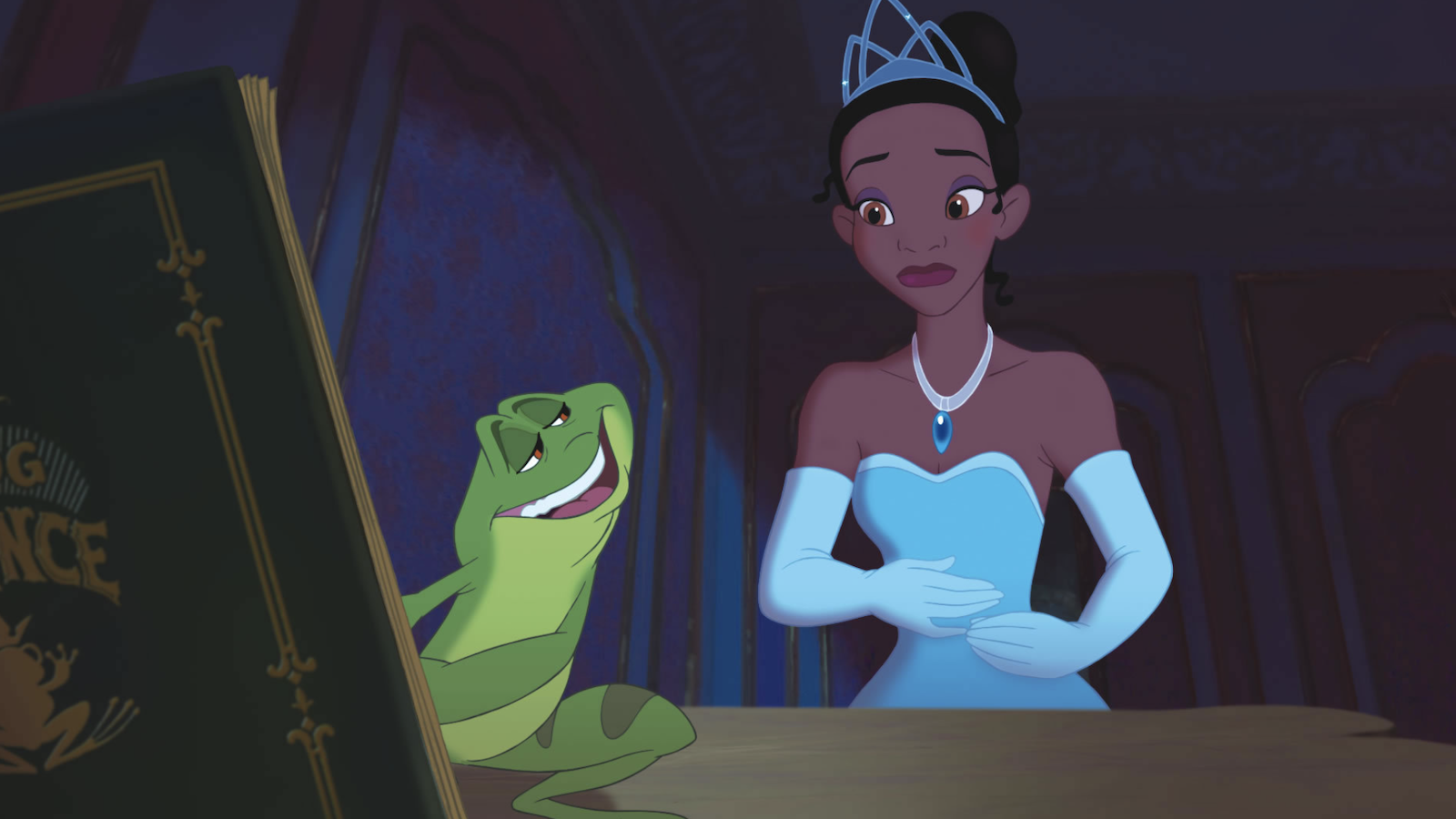 cartoon still of a green frog holding a book and talking to a Black girl dressed as a princess