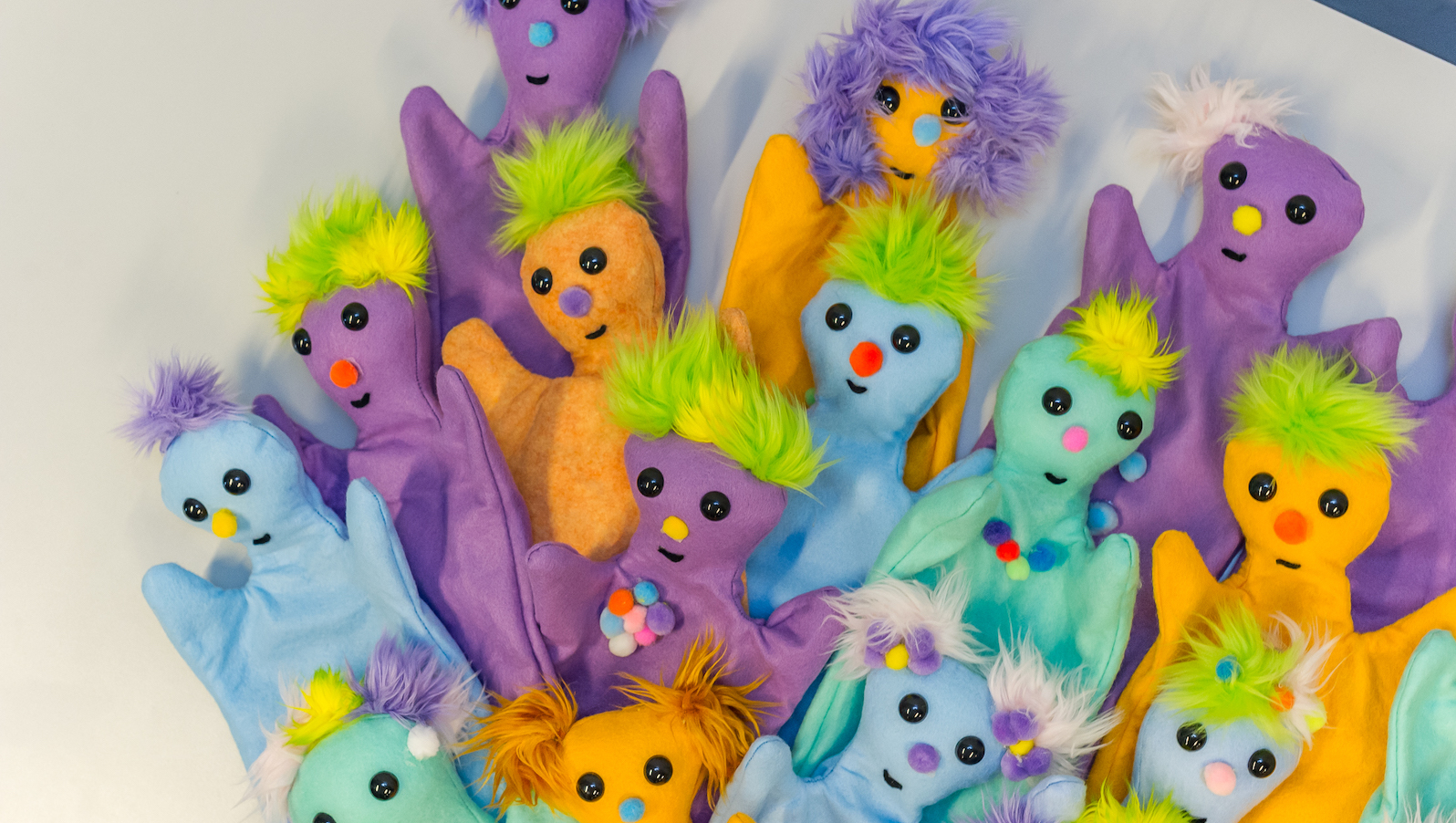 Brightly colored puppets in a pile