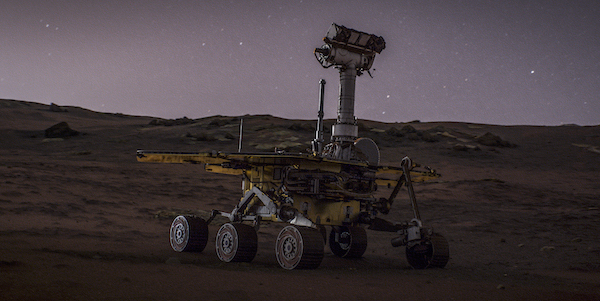 A land rover robot explores Mars against a purple sky