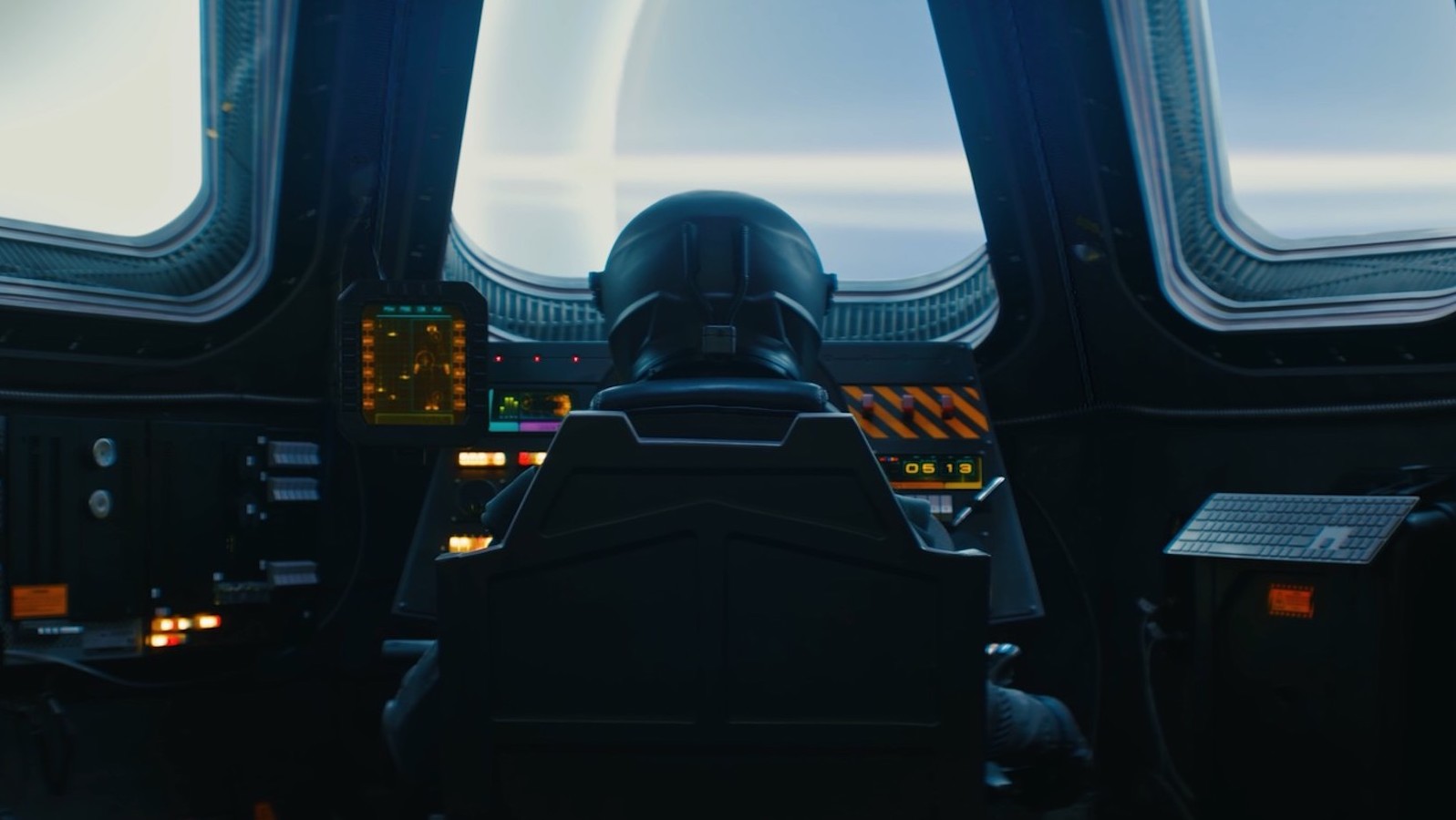 An image of a helmeted pilot in a spaceship, seen from behind, looking out a front windshield