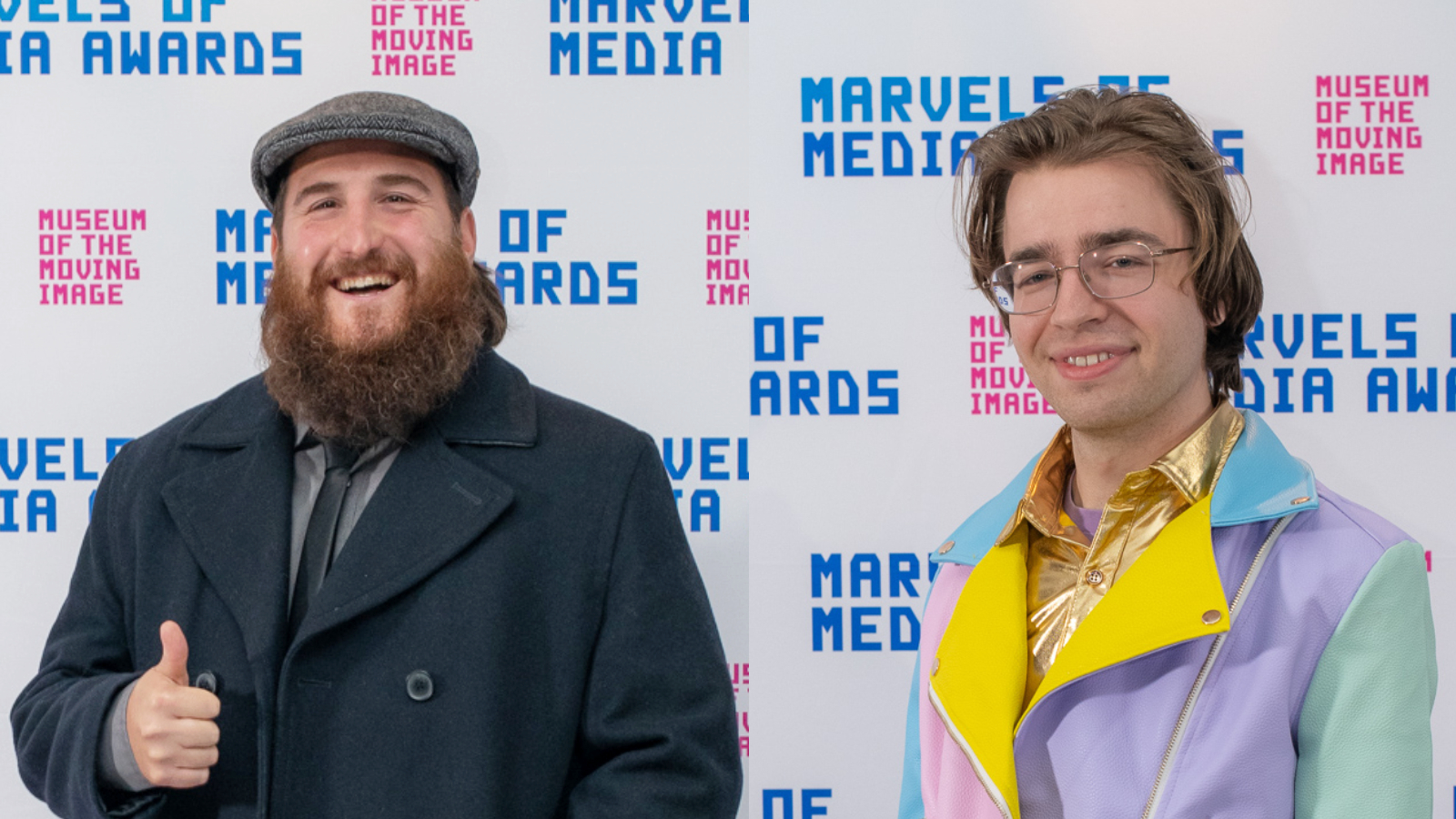 A bearded person in a coat smiles and gives the thumbs up and another wearing a multicolored jacket and glasses smiles, both with a Museum and Marvels of Media step-and-repeat in the background