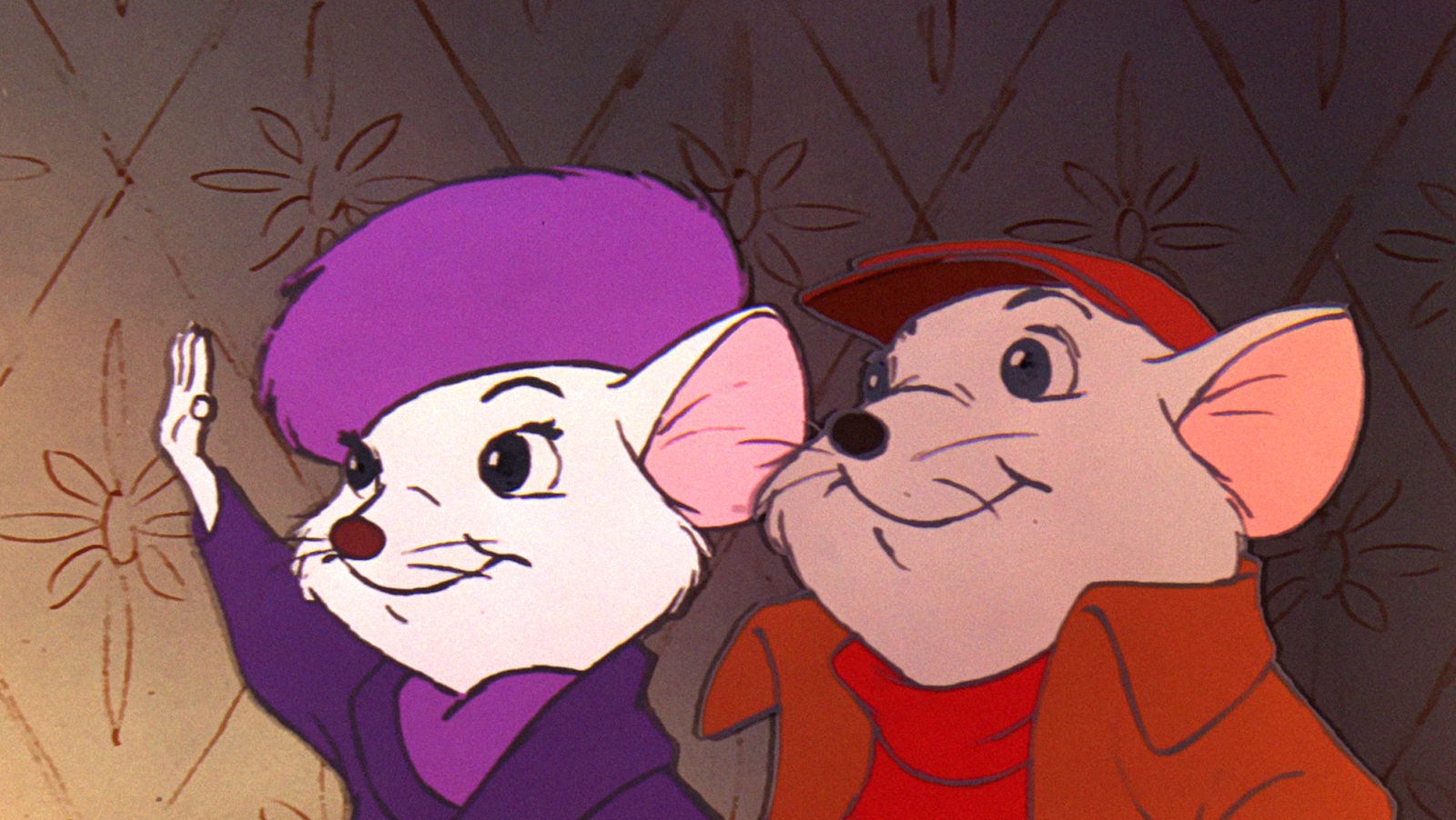 Two adorable mice, one in a purple hat and another in a red chapeau look offscreen smiling.