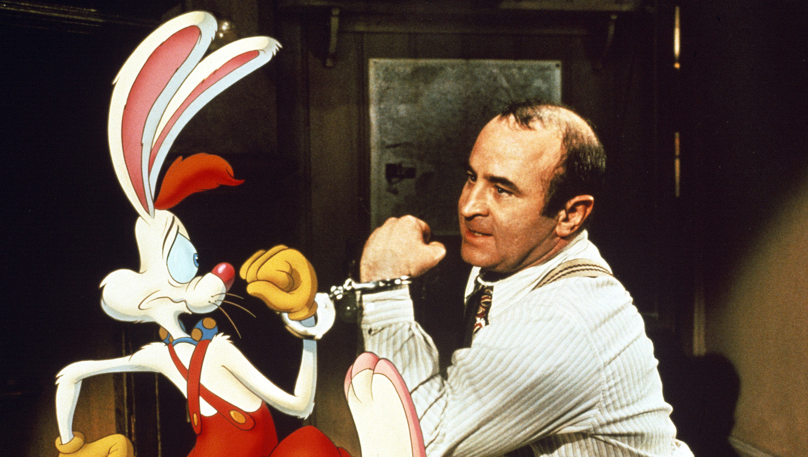 A man and an animated rabbit handcuffed together
