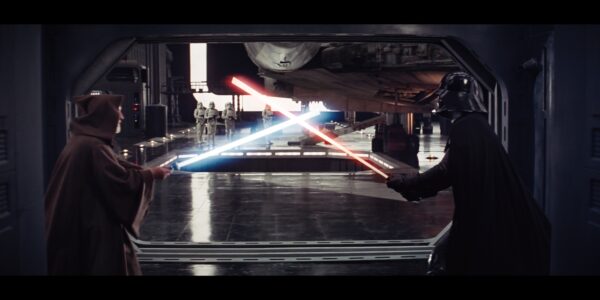 a man in a cloak and a man in a dark helmet and cape fight with light sabers