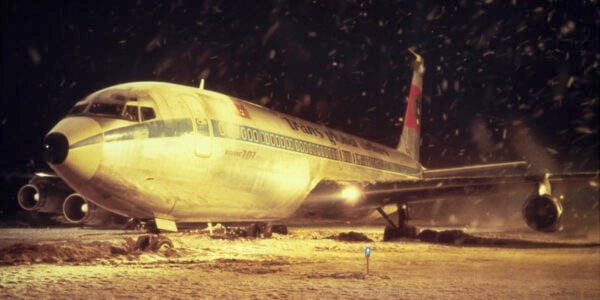 A jumbo airliner on the runway amidst snowfall